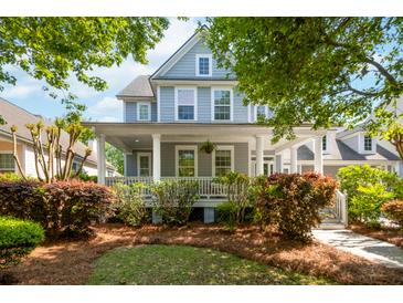 Charming two-story home featuring a welcoming front porch with white columns and beautifully landscaped yard at 1977 Pierce St, Charleston, SC 29492