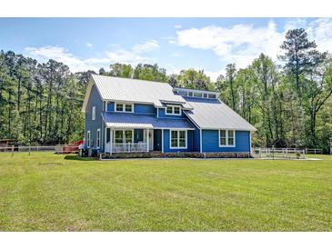 Charming two-story blue home with metal roof and inviting front porch at 2102 Williams Rd, Ruffin, SC 29475