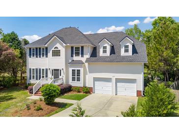 Beautiful two-story home featuring a two-car garage, manicured lawn and mature trees at 2290 Deer Sight Way, Mount Pleasant, SC 29466