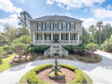 Beautiful two-story home with front porch and circular driveway with fountain at 2444 Darts Cove Way, Mount Pleasant, SC 29466