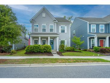 Charming two-story home with gray siding, white trim, landscaped yard, and welcoming blue front door at 249 Oak View Way, Summerville, SC 29483