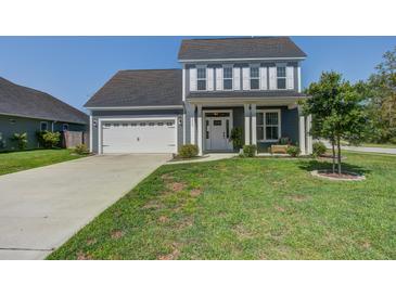 Charming two-story home with a well-manicured lawn, attached two-car garage, and inviting front porch at 2880 Cavalcade Cir, Johns Island, SC 29455