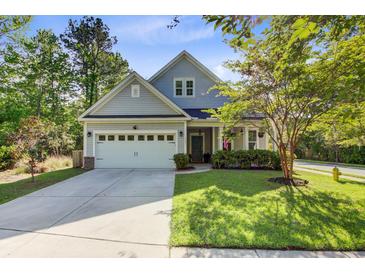 Charming two-story home with well-manicured lawn, attached garage, and inviting front porch at 3001 Grand Bay Ln, Johns Island, SC 29455