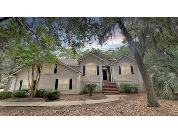 Charming two-story home featuring neutral siding, black shutters, and a brick stairway entrance at 3023 Maritime Forest Dr, Johns Island, SC 29455