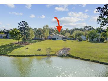 Lakes of Summerville pond-view backyard with a well-maintained lawn at 318 Seneca River Dr, Summerville, SC 29485