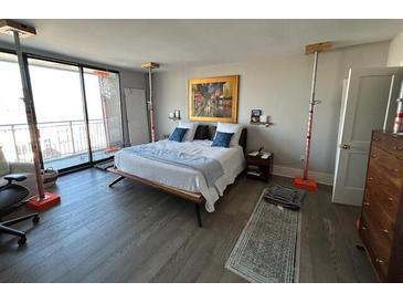 Spacious bedroom featuring floor-to-ceiling windows, hardwood floors and natural light at 330 Concord St # 14D, Charleston, SC 29401