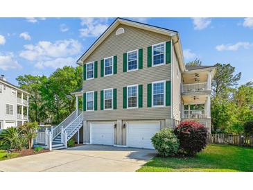 Charming home with two-car garage, landscaped yard, and double porches perfect for outdoor enjoyment at 339 Clayton Dr, Charleston, SC 29414