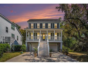 Charming two-story home features a spacious porch, light-colored siding, dark shutters, and well-manicured landscaping at 3717 Tip Ln, Mount Pleasant, SC 29466