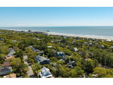 Stunning aerial view of a home near the beach, with lush greenery and ocean views at 409 W Indian Ave, Folly Beach, SC 29439