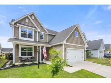 Charming two-story home with a well-manicured lawn and an attached garage in a friendly neighborhood at 476 Foxbank Plantation Blvd, Moncks Corner, SC 29461