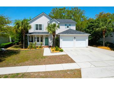 Charming two-story home featuring a well-manicured lawn and an attached two-car garage at 1006 Wayfarer Ln, Charleston, SC 29412