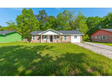 Charming single-story brick home featuring a well-maintained lawn, classic design, and mature trees at 1104 Margaret Dr, Ladson, SC 29456