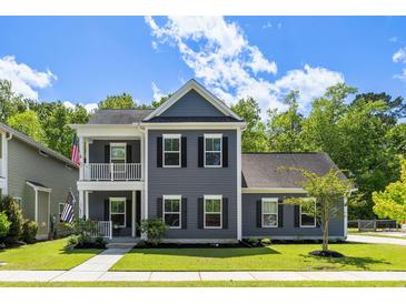 Charming two-story home with a welcoming porch and beautifully landscaped front yard at 1233 Updyke Dr, Johns Island, SC 29455