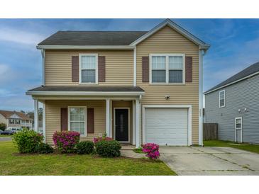 Charming two-story home with vinyl siding, well-maintained landscaping, and an attached garage at 3033 Kinswood Ln, Ladson, SC 29456