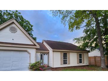 Charming one-story home with attached garage, well-maintained lawn, and inviting curb appeal in a quiet neighborhood at 315 Indigo Rd, Goose Creek, SC 29445