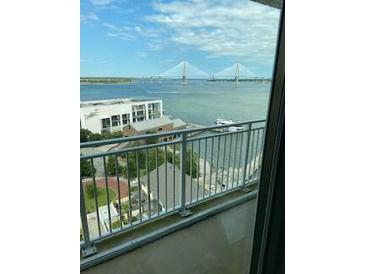 Balcony view overlooking the water, city buildings, and a large bridge in the background at 330 Concord St # 15C, Charleston, SC 29401