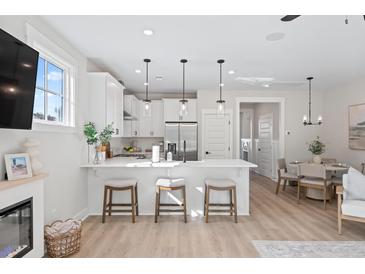 Bright, modern kitchen with white cabinetry, stainless steel appliances, and a breakfast bar with seating at 333 Bremerton Dr, Goose Creek, SC 29445