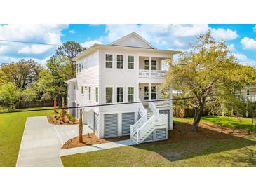 Stunning two-story home featuring a light exterior, double porches, manicured landscaping, and a private driveway at 3683 Nassas St, Mount Pleasant, SC 29466