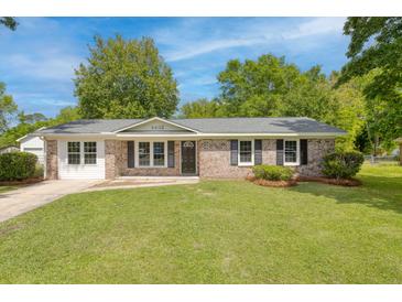 Charming brick home with black shutters and a well-manicured front yard with a lovely green lawn at 4432 Logwood Drive, Ladson, SC 29456