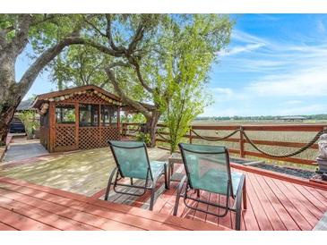 Relaxing back deck featuring a screened gazebo, marsh view and two chairs at 5703 St Angela Dr, North Charleston, SC 29418