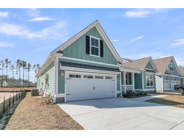 Charming coastal home featuring a two-car garage and light blue siding at 701 Maynard Ln, Summerville, SC 29486