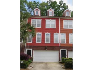 Colorful townhouse exterior with brick base, garage, and dormer windows at 9163 Parlor Dr, Ladson, SC 29456