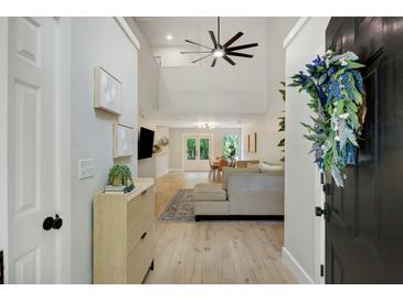 Inviting foyer leads into a bright, open-concept living space with high ceilings and luxury vinyl plank flooring at 1027 Island View Ct, Charleston, SC 29492