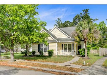 Charming home featuring a lush lawn, mature trees, and inviting front porch at 108 Gaslight Blvd, Summerville, SC 29483