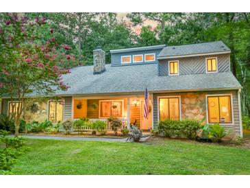Charming two-story home featuring stone accents, mature landscaping, and a welcoming front porch at 111 Garden Hill Rd, Summerville, SC 29483
