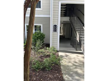 Exterior view of building with visible unit numbers and access to upper levels at 1300 Park West Blvd # 516, Mount Pleasant, SC 29466