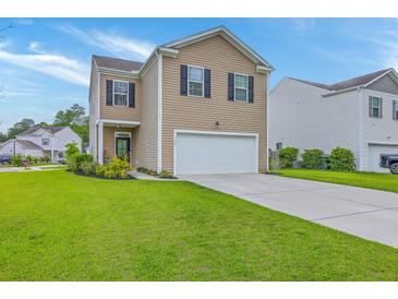 Charming two-story home featuring well-maintained lawn, attached garage, and classic curb appeal at 134 Stoney Creek Way, Moncks Corner, SC 29461