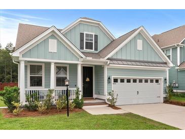Charming single-Gathering home with a manicured lawn, inviting porch, and an attached two-car garage at 154 Boots Branch Rd, Summerville, SC 29485