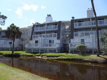 Waterfront condo building featuring multiple decks and pleasant surroundings at 237 Driftwood Ln, Edisto Island, SC 29438