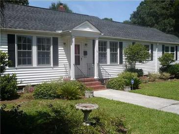 Charming single-story home with landscaped front yard and inviting entrance, featuring classic design and manicured lawn at 32 Rosedale Dr, Charleston, SC 29407