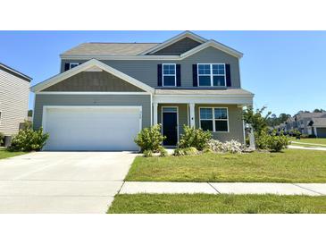 Charming two-story home with manicured lawn and a two-car garage, freshly painted in neutral tones at 362 Lake Ridge Blvd, Summerville, SC 29486