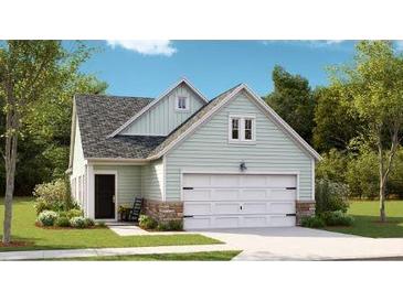 Charming home featuring mint green siding, stone accents, black door and a two-car garage, all surrounded by a lush, well-maintained lawn at 1016 Sagegrass St, Summerville, SC 29485