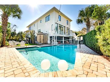 Inviting backyard pool with clear water, lounge chairs and well manicured yard at this home at 109 Carolina Blvd, Isle of Palms, SC 29451