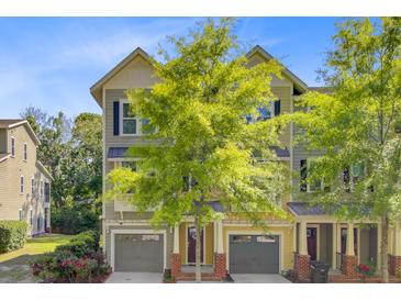 Charming townhome with attached garage, lush landscaping, and a inviting front entrance at 1215 Dingle Rd, Mount Pleasant, SC 29466