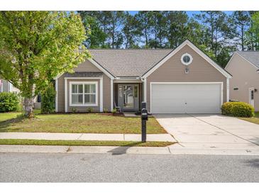 Charming single-story home with manicured lawn, attached garage, and mature trees at 1362 Palm Cove Dr, Charleston, SC 29492