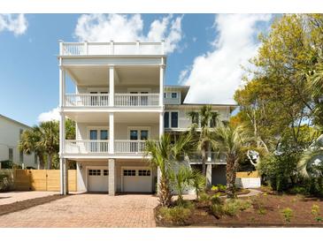 Stunning three-story home features multiple balconies, two-car garage, and beautiful brick driveway at 3007 Cameron Blvd, Isle of Palms, SC 29451