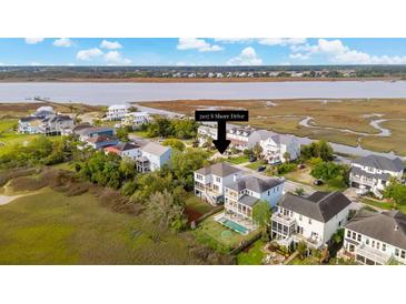 Beautiful home on the water with a pool in the backyard and gorgeous landscaping at 3107 S Shore Dr, Charleston, SC 29407