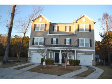 Charming townhome with symmetrical facade, individual garages, and inviting driveways at 4210 Scharite St, Charleston, SC 29414