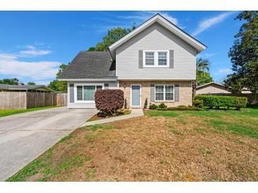 Charming two-story home featuring a well-maintained front yard, blue door, and brick and siding accents at 422 Temple Rd, Ladson, SC 29456