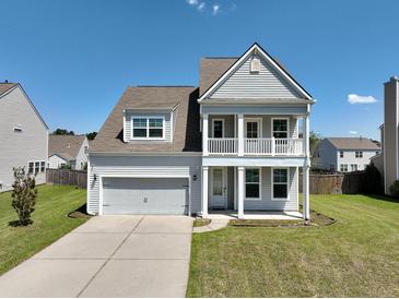 Charming two-story home with a double front porch, well-maintained lawn and a two car garage at 514 Morelets Dr, Moncks Corner, SC 29461