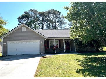 Charming single-story home with a well-maintained lawn, attached garage and colorful flower boxes at 9914 Levenshall Dr, Ladson, SC 29456