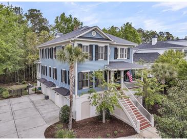 Charming multi-story home boasting a welcoming porch, well-manicured landscaping, and ample parking at 1531 Capel St, Mount Pleasant, SC 29466