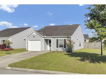 Charming single-story home with a well-maintained lawn and attached garage, set under a clear blue sky at 157 Tyger St, Summerville, SC 29485