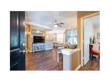 Inviting living room featuring hardwood floors, a ceiling fan, and comfortable seating near large windows at 1615 Chatelain Way, Mount Pleasant, SC 29464