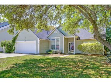 Charming single-story home featuring a well-manicured lawn and attached two car garage at 208 Evesham Dr, Summerville, SC 29485
