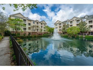 Beautiful community pond with fountain, surrounded by lush greenery and apartments at 2244 Ashley Crossing Drive Dr # 621, Charleston, SC 29414